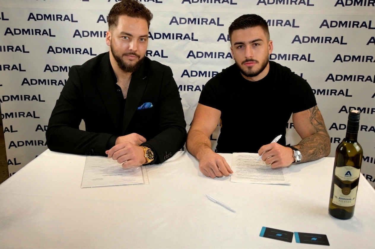 Amil Tutić holding the Admiral branded t-shirt as the new brand ambassador